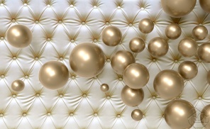 Позолоченные шары на фоне мебельной обивки